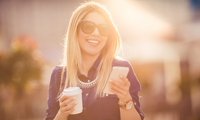 A woman showing her bright smile after getting her teeth whitened by her Palmdale, CA dentist.